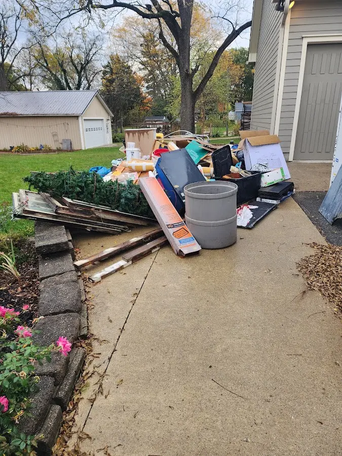 Dumpster being loaded with debris for 3 Yard Dumpster Rental in Fond du Lac